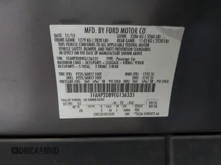 2014 Ford Taurus SE with VIN 1FAHP2D89EG136335, listed as a IAAI auction lot 41880655 with 211,635 mi miles. Bid and sale history available at carsss.com. Image 9.