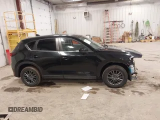 2021 Mazda CX-5 Touring with VIN JM3KFBCM1M1380409, listed as a IAAI auction lot 41677537 with 55,319 mi miles. Bid and sale history available at carsss.com. Image 13.
