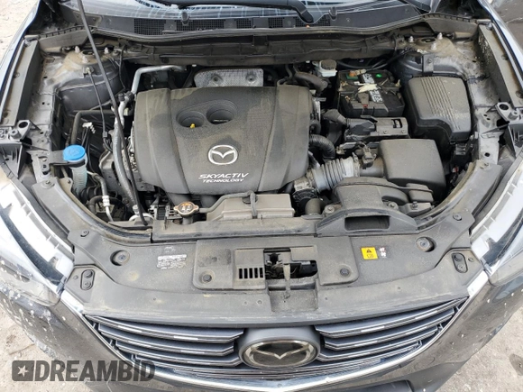 2016 Mazda CX-5 Grand Touring z VIN JM3KE4DY5G0741800, wystawiony jako Copart lot #58565455 z przebiegiem 33 675 mil mil oraz Szkoda całkowita • Salvage title. Historia ofert i sprzedaży dostępna na DreamBid. Obrazek 12.