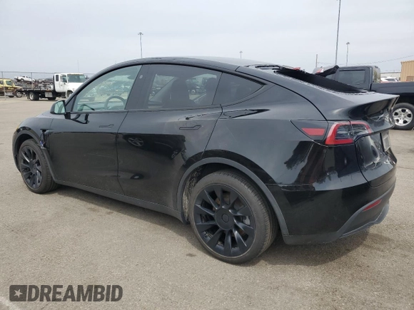 2023 Tesla Model Y Long Range z VIN 7SAYGDEE0PF869710, wystawiony jako Copart lot #52885365 z przebiegiem 13 919 mil mil oraz Szkoda całkowita • Salvage title. Historia ofert i sprzedaży dostępna na DreamBid. Obrazek 2.