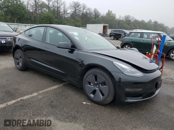 2023 Tesla Model 3 with VIN 5YJ3E1EA9PF687187, listed as a Copart auction lot 61044055 with 7,007 mi miles and Salvage title. Bid and sale history available at DreamBid. Image 4.