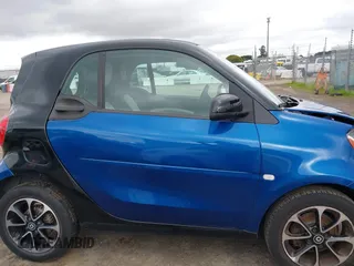 2016 Smart fortwo Passion z VIN WMEFJ5DA8GK059871, wystawiony jako IAAI lot #41624917 z przebiegiem 90 906 mil mil oraz . Historia ofert i sprzedaży dostępna na DreamBid. Obrazek 13.
