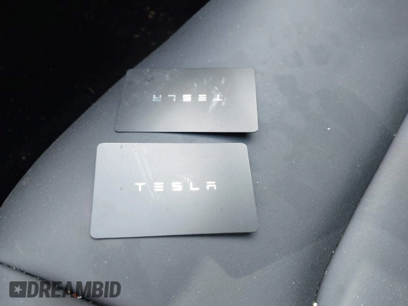 2023 Tesla Model 3 with VIN 5YJ3E1EA5PF407054, listed as a IAAI auction lot 42313770 with 57,621 mi miles and . Bid and sale history available at DreamBid. Image 11.