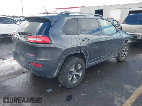 2015 Jeep Cherokee Trailhawk with VIN 1C4PJMBS9FW785545, listed as a IAAI auction lot 41573197 with 124,304 mi miles. Bid and sale history available at carsss.com. Image 4.