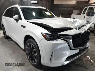 2024 Mazda CX-90 S Premium z VIN JM3KKDHCXR1103272, wystawiony jako IAAI lot #40301969 z przebiegiem 5 235 mil mil oraz . Historia ofert i sprzedaży dostępna na DreamBid. Obrazek 1.