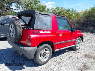 1998 Chevrolet Tracker z VIN 2CNBE1866W6924835, wystawiony jako IAAI lot #41821459 z przebiegiem 54 512 mil mil oraz . Historia ofert i sprzedaży dostępna na DreamBid. Obrazek 4.
