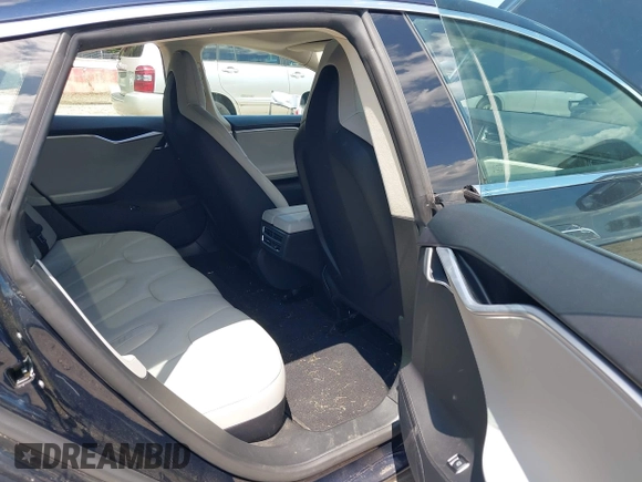 2013 Tesla Model S with VIN 5YJSA1CN0DFP21851, listed as a IAAI auction lot 42557791 with 106,328 mi miles and . Bid and sale history available at DreamBid. Image 8.