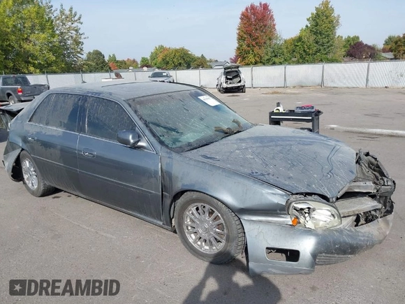 2004 Cadillac DeVille DHS z VIN 1G6KE57Y74U119605, wystawiony jako IAAI lot #40555057 z przebiegiem Nie podano mil oraz . Historia ofert i sprzedaży dostępna na DreamBid. Obrazek 1.