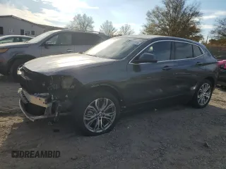 2021 BMW X2 xDrive28i with VIN WBXYJ1C07M5S21169, listed as a Copart auction lot 77829574 with 24,173 mi miles and Salvage Title. Bid and sale history available at carsss.com. Image 1.
