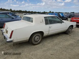 1984 Cadillac Eldorado z VIN 1G6AL5782EE603047, wystawiony jako Copart lot #76777394 z przebiegiem 33 384 mil mil oraz Tytuł czysty. Historia ofert i sprzedaży dostępna na DreamBid. Obrazek 3.