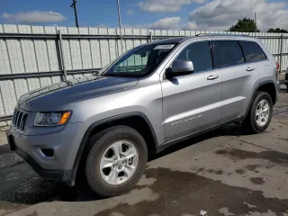 2016 Jeep Grand Cherokee Laredo with VIN 1C4RJFAG2GC390501, listed as a Copart auction lot 62134935 with 104,901 mi miles and Salvage title. Bid and sale history available at DreamBid. Image 1.