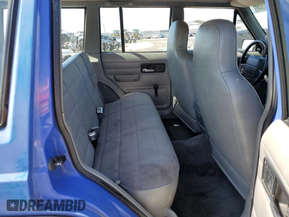 1996 Jeep Cherokee SE with VIN 1J4FT28S1TL108840, listed as a Copart auction lot 46951195 with 257,004 mi miles and Salvage Title. Bid and sale history available at carsss.com. Image 11.