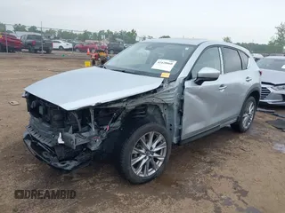 2021 Mazda CX-5 Grand Touring with VIN JM3KFBDM4M0371496, listed as a IAAI auction lot 42428860 with 113,735 mi miles and . Bid and sale history available at DreamBid. Image 2.