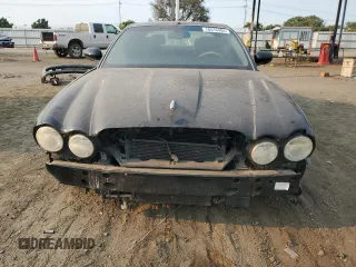 2004 Jaguar XJ with VIN SAJWA73B74TG18082, listed as a Copart auction lot 70516404 with 0 mi miles and Salvage Title. Bid and sale history available at carsss.com. Image 5.