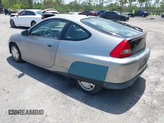 2004 Honda Insight z VIN JHMZE14744T000527, wystawiony jako IAAI lot #42378630 z przebiegiem 1 360 mil mil oraz . Historia ofert i sprzedaży dostępna na DreamBid. Obrazek 3.