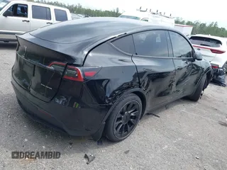 2023 Tesla Model Y Long Range with VIN 7SAYGAEE8PF928923, listed as a IAAI auction lot 41880988 with 18,468 mi miles. Bid and sale history available at carsss.com. Image 4.