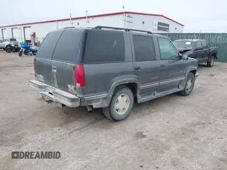 1999 GMC Yukon with VIN 1GKEK13R0XJ803237, listed as a IAAI auction lot 41736117 with 295,793 mi miles. Bid and sale history available at carsss.com. Image 4.