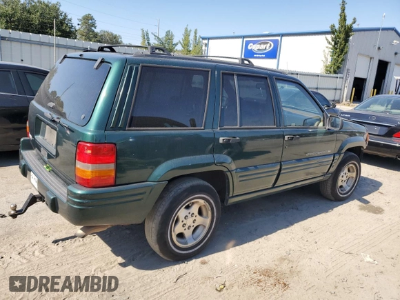 1998 Jeep Grand Cherokee with VIN 1J4FX48S8WC281615, listed as a Copart auction lot 77305594 with 128,393 mi miles and Salvage title. Bid and sale history available at DreamBid. Image 3.