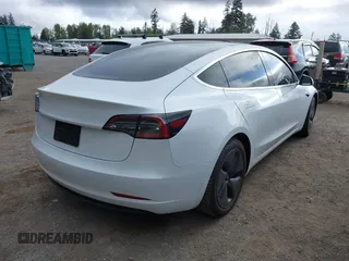 2020 Tesla Model 3 Standard Range Plus with VIN 5YJ3E1EA5LF613002, listed as a IAAI auction lot 42129085 with 55,672 mi miles. Bid and sale history available at carsss.com. Image 4.