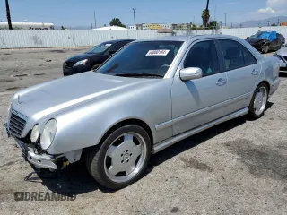 2000 Mercedes-Benz E with VIN WDBJF74J7YB055624, listed as a Copart auction lot 63880184 with 71,355 mi miles and Salvage Title. Bid and sale history available at DreamBid. Image 1.