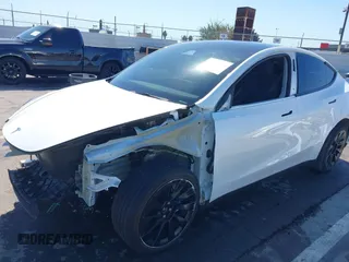 2023 Tesla Model Y Long Range with VIN 7SAYGDEEXPA129790, listed as a IAAI auction lot 41735721 with 20,402 mi miles and . Bid and sale history available at DreamBid. Image 6.