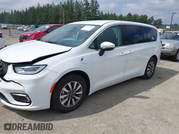 2023 Chrysler Pacifica Hybrid Touring L with VIN 2C4RC1L77PR541513, listed as a IAAI auction lot 42433421 with 53,979 mi miles and . Bid and sale history available at DreamBid. Image 2.