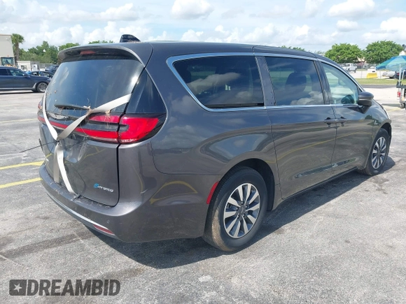 2023 Chrysler Pacifica Hybrid Touring L with VIN 2C4RC1L74PR579782, listed as a IAAI auction lot 42487390 with Not provided miles and . Bid and sale history available at DreamBid. Image 4.