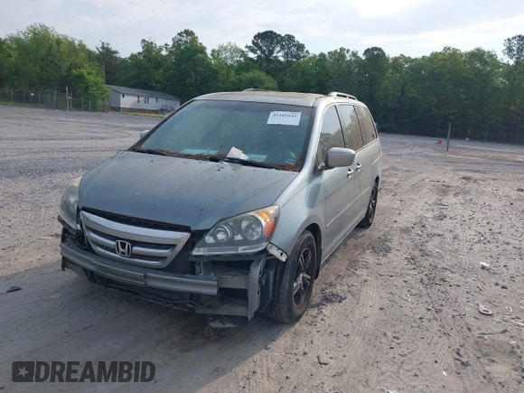 2005 Honda Odyssey TOURING with VIN 5FNRL38815B027811, listed as a IAAI auction lot 42105642 with 303,913 mi miles. Bid and sale history available at carsss.com. Image 2.