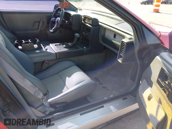 1986 Pontiac Fiero z VIN 1G2PG9791GP267415, wystawiony jako IAAI lot #42461769 z przebiegiem Nie podano mil oraz . Historia ofert i sprzedaży dostępna na DreamBid. Obrazek 5.