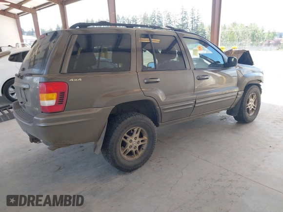1999 Jeep Grand Cherokee Limited z VIN 1J4GW68N0XC512229, wystawiony jako IAAI lot #42189815 z przebiegiem 230 028 mil mil oraz . Historia ofert i sprzedaży dostępna na DreamBid. Obrazek 4.
