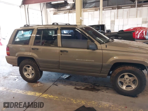 1996 Jeep Grand Cherokee Laredo with VIN 1J4GZ58S9TC293787, listed as a IAAI auction lot 41179368 with 141,755 mi miles. Bid and sale history available at carsss.com. Image 14.