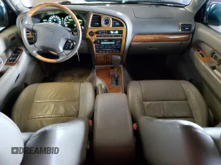 2001 Infiniti QX4 with VIN JNRDR09X21W204448, listed as a Copart auction lot 82619574 with 114,520 mi miles and Salvage Title. Bid and sale history available at DreamBid. Image 8.