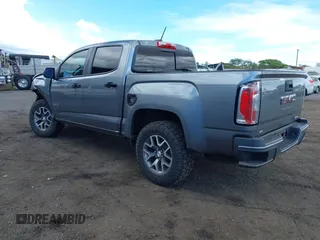 2021 GMC Canyon 4WD AT4 z VIN 1GTG6FEN8M1275345, wystawiony jako IAAI lot #42045878 z przebiegiem 68 299 mil mil oraz . Historia ofert i sprzedaży dostępna na DreamBid. Obrazek 3.