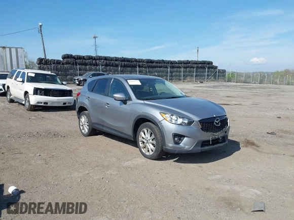 2014 Mazda CX-5 Grand Touring with VIN JM3KE4DY7E0311893, listed as a IAAI auction lot 42090872 with 102,154 mi miles and . Bid and sale history available at DreamBid. Image 1.
