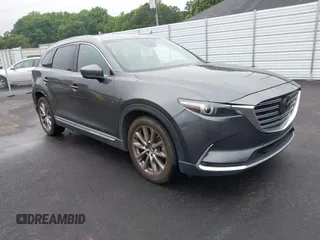 2019 Mazda CX-9 Grand Touring z VIN JM3TCADY4K0323200, wystawiony jako IAAI lot #42437800 z przebiegiem 138 849 mil mil oraz . Historia ofert i sprzedaży dostępna na DreamBid. Obrazek 1.