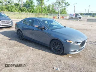 2024 Mazda 3 S Carbon Edition with VIN 3MZBPBCM6RM411828, listed as a IAAI auction lot 42802141 with 40,061 mi miles and . Bid and sale history available at DreamBid. Image 1.