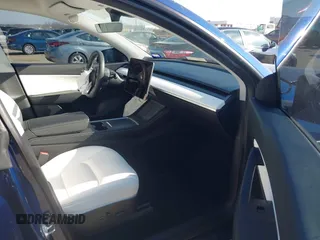 2021 Tesla Model Y Standard Range with VIN 5YJYGDED5MF121874, listed as a IAAI auction lot 41238170 with 72,041 mi miles and . Bid and sale history available at DreamBid. Image 5.