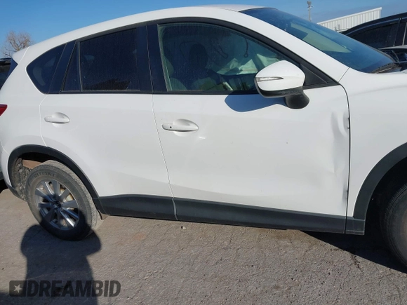 2016 Mazda CX-5 Touring z VIN JM3KE2CY9G0807688, wystawiony jako IAAI lot #41039438 z przebiegiem 169 483 mil mil oraz . Historia ofert i sprzedaży dostępna na DreamBid. Obrazek 14.