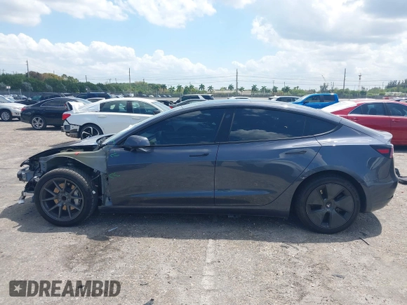 2023 Tesla Model 3 with VIN 5YJ3E1EAXPF575448, listed as a IAAI auction lot 42019288 with 33,859 mi miles and . Bid and sale history available at carsss.com. Image 15.