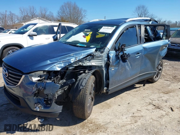 2016 Mazda CX-5 Grand Touring with VIN JM3KE2DY2G0715272, listed as a IAAI auction lot 41590492 with 134,176 mi miles. Bid and sale history available at carsss.com. Image 2.