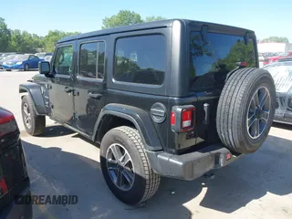 2023 Jeep Wrangler Sahara with VIN 1C4HJXEN5PW702268, listed as a IAAI auction lot 42288704 with 57,240 mi miles and . Bid and sale history available at DreamBid. Image 3.
