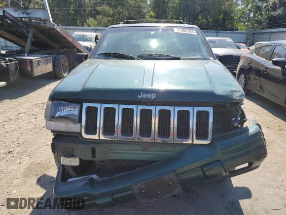 1998 Jeep Grand Cherokee with VIN 1J4FX48S8WC281615, listed as a Copart auction lot 77305594 with 128,393 mi miles and Salvage title. Bid and sale history available at DreamBid. Image 5.
