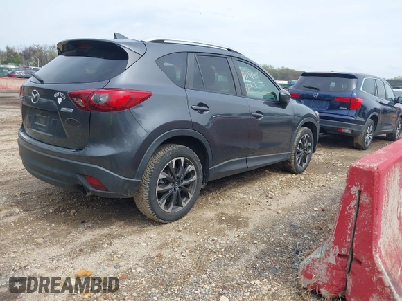 2016 Mazda CX-5 Grand Touring with VIN JM3KE4DYXG0830150, listed as a IAAI auction lot 41961007 with 142,570 mi miles and . Bid and sale history available at DreamBid. Image 4.
