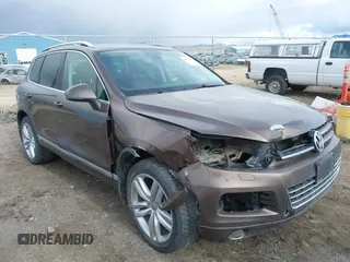 2013 Volkswagen Touareg Lux with VIN WVGEF9BP1DD012851, listed as a IAAI auction lot 41732391 with 123,283 mi miles and . Bid and sale history available at DreamBid. Image 1.