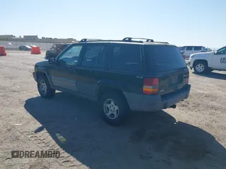 1997 Jeep Grand Cherokee Laredo with VIN 1J4GZ58S4VC633205, listed as a IAAI auction lot 41727571 with 201,228 mi miles. Bid and sale history available at carsss.com. Image 3.