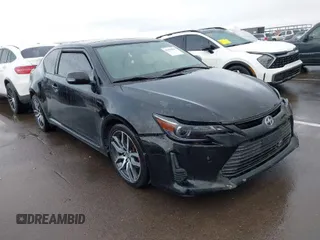 2015 Scion tC with VIN JTKJF5C79FJ003404, listed as a IAAI auction lot 41756024 with 128,906 mi miles. Bid and sale history available at carsss.com. Image 1.