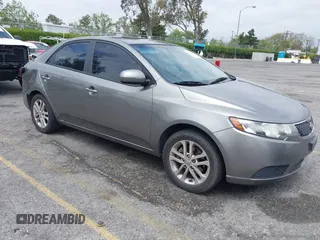 2012 Kia Forte EX with VIN KNAFU4A2XC5560585, listed as a IAAI auction lot 42121133 with 151,079 mi miles. Bid and sale history available at carsss.com. Image 1.