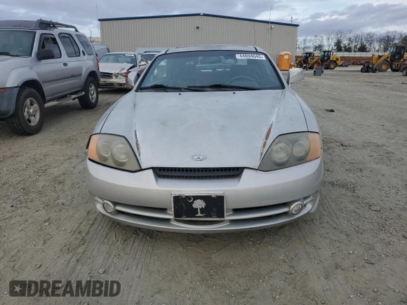 2003 Hyundai Tiburon GT z VIN KMHHN65F63U064962, wystawiony jako Copart lot #44804045 z przebiegiem 186 171 mil mil oraz Szkoda całkowita • Salvage title. Historia ofert i sprzedaży dostępna na DreamBid. Obrazek 5.