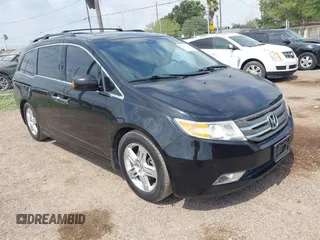 2013 Honda Odyssey Touring with VIN 5FNRL5H95DB086041, listed as a IAAI auction lot 42477974 with 213,343 mi miles and . Bid and sale history available at DreamBid. Image 1.