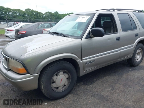 1999 GMC Jimmy SLE z VIN 1GKCS13W0X2512048, wystawiony jako IAAI lot #42364175 z przebiegiem 195 301 mil mil oraz . Historia ofert i sprzedaży dostępna na DreamBid. Obrazek 6.